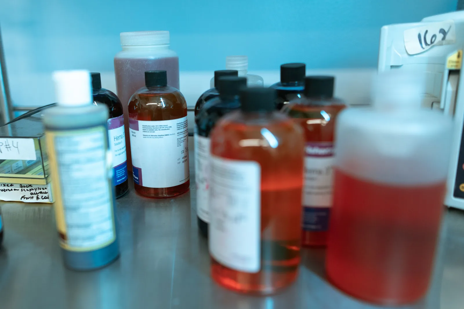 Close-up of various labeled chemical bottles on a lab bench, illustrating biochemical research. Pool Chemical Inventory Spreadsheet for Solo Techs: What Columns Matter